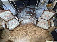 Pair of Victorian chairs with carved wooden frames and floral upholstery, some scratches visible on wood.