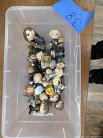 Top view of all the mini Funko Pop figures arranged in a plastic container showing assorted characters from Game of Thrones and one from Harry Potter