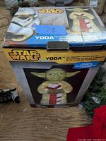Original boxed Star Wars Yoda 28-inch holiday lighted decor product with branding and image of Yoda holding candy cane on box top and front.