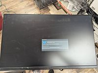 Front view of a Dell U2417H monitor powered on, showing a message about no video source detected.