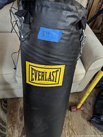 Full view of the black Everlast punching bag with visible brand logo and black hanging straps.