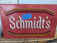 Unlit Schmidt's light up sign showing white tubing on maroon background with red and brown border tubing.