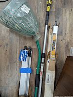 Overview photo showing entire lot: pick up rake, light bulb changer, and two tool clamp guides