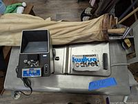 Microfilm viewer and golf clubs in bag on table with microfilm box