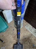 Full view of the Shark Rocket vacuum cleaner showing the brand and control buttons on the handle with folded upright design.
