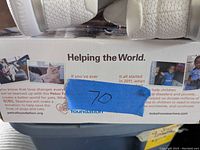 Photo of shoe box with charity tagging and lot number label.