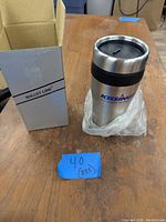 Photo of a stainless steel travel cup branded 'Kissing' alongside its Bullet Line box, with a blue label indicating quantity 40 (x24)