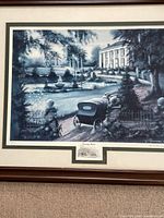 Close-up of the print showing the vintage car, plantation house, fountain, and garden elements, along with the title cutout and signature in pencil.