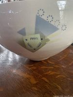 Side view showing geometric pattern on the bowl.