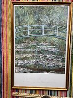 Framed poster showing Monet's Water Lilies with bridge, clear in good condition.