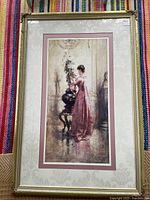 Full view of framed vintage print showing woman in a pink Victorian dress arranging flowers in a vase, double matting with silk cover, ornate frame