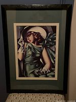 Framed art print showing the full piece with black frame and green mat.