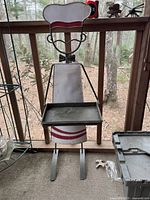 Full view of the vintage metal restaurant butler with tray, showing the height and width relative to the balcony railing and surrounding scenery.