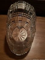 Top view of vintage cut glass basket showing starburst design on the base and intricate geometric cuts on the walls.