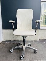 Front view showing seat, back, arms, and base