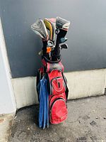Front and side views of red golf bag filled with clubs and attached blue towel