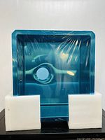 Top-down view of the blue protective-wrapped square kitchen sink with foam corner protectors.