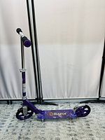 Full side view of the purple Razor kick scooter showing handlebar and deck with logo.