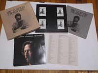 Photo showing box set open with 4 chrome cassettes and 2 booklets arranged on white backing.