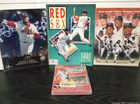Lot contents showing Pedro Martinez poster, 1990 Official Red Sox Yearbook, DVD and photo pack.