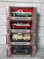 Four Road Signature Collector's Edition diecast cars stacked in retail packaging. Cars visible: green and white pickup, red and white car, cream pickup, black pickup.