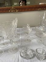 Photo of stemmed pinwheel cut crystal glasses and small stemmed glasses with intricate starburst patterns
