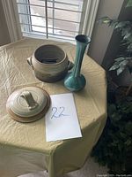 Overview of the Blue Mountain Pottery vase and Donn Zver casserole dish with lid on a table near window.