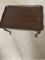 Top view of the rectangular dark wood coffee table showing surface wear and scratches