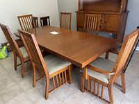 Front view of extended table with six chairs surrounding