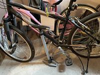 Side view of the Norco Plateau men's mountain bike showing frame, tires, pedals, and air pump beside it.