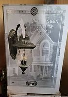 Original product box showing one Hampton Bay Designer Edition wall lantern with oil-rubbed bronze finish and clear water glass globe.