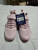 Pair of brand new kids Champion pink runners size 2 with tags, view from front showing toe mesh and logo strap.