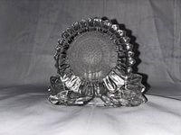 Front view of clear glass sunflower shaped candle holder showing detailed petal design and textured center.