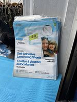 Front view of pack showing brand name Maxam, showing 3 reusable self-adhesive laminating sheets per pack with glossy finish, acid free, letter size.