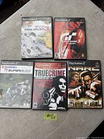 Photo of 5 PlayStation 2 games: TOCA Race Driver 3, Gran Turismo 3 A-Spec, Suzuki TT Superbikes, True Crime: Streets of LA (Greatest Hits), and NARC.