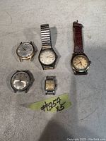 Lot of 5 wristwatches showing overall condition and differences in styles and bands.