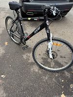 Full side view of black CCM mountain bike with 26" wheels and memory foam seat, showing overall condition.