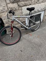 Full right-side view of bike showing silver frame and red suspension fork