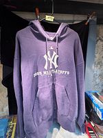 Front view of purple hoodie with New York Yankees logo and 2003 MLB Playoffs text on chest