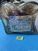 Clear plastic bag containing vintage army forces play set with 100 pieces, front label visible
