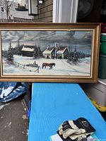 Full view of the vintage oil painting showing a winter landscape with a horse, sleigh, buildings, and snow-covered trees in a gilded frame.