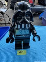 Front view of LEGO Star Wars Darth Vader alarm clock showing digital time display and figure details.