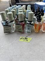 Front view showing row of home fragrance refill bottles with white and light blue caps, some labeled Wallflowers with scents White Tea & Sage, Blush Amber Peony, Fresh Sheets.