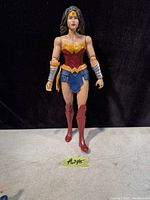 Front view of the Wonder Woman action figure standing upright on a surface with a black background.