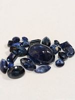 Group of loose genuine sapphire gemstones on a white background.