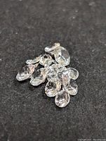 Group of loose white sapphire gemstones displayed on a black surface