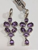 Front view of pair of silver amethyst drop earrings showing purple stones set in sterling silver