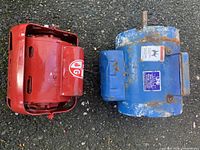 Top view of two electric motors, one red and one blue, showing their casing and labels.