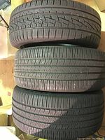 Three stacked tires showing tread wear and overall condition