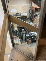 Fixed tilt mirror showing reflective surface and surrounding warehouse environment.